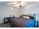 Bedroom with a ceiling fan, black metal bed frame, and carpet at 5305 Lenoir Ct, Plant City, FL 33566