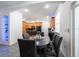 Bright dining area with a sleek table, six chairs, and view of the modern kitchen at 5305 Lenoir Ct, Plant City, FL 33566