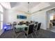 Modern dining room with glass table, black chairs, and tray ceiling with pendant lighting at 5305 Lenoir Ct, Plant City, FL 33566