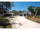 Attractive house with a large driveway, detached garage, and well-maintained lawn for a welcoming curb appeal at 5305 Lenoir Ct, Plant City, FL 33566