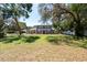 Charming two-story home with a well-manicured lawn, mature trees, and elegant exterior features at 5305 Lenoir Ct, Plant City, FL 33566