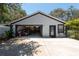 Spacious detached garage with dark trim, offering ample storage and parking, plus a convenient side door at 5305 Lenoir Ct, Plant City, FL 33566