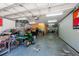 Large garage interior featuring a high ceiling and ample space for vehicles, equipment and storage at 5305 Lenoir Ct, Plant City, FL 33566