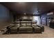 Spacious home theater with tiered seating, plush leather recliners, and built-in shelving at 5305 Lenoir Ct, Plant City, FL 33566