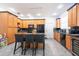 Bright kitchen features wood cabinetry, a breakfast bar with seating, and modern, black appliances at 5305 Lenoir Ct, Plant City, FL 33566