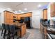 Bright kitchen features wood cabinetry, a breakfast bar with seating, and modern, black appliances at 5305 Lenoir Ct, Plant City, FL 33566