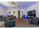 Comfortable living room area with home theater seating, large television, and stylish ceiling fans at 5305 Lenoir Ct, Plant City, FL 33566