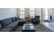 Cozy living room with plush gray seating, area rug, and clerestory windows at 5305 Lenoir Ct, Plant City, FL 33566
