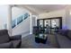 Elegant living room with sleek furniture, glass display shelves, carpet and statement columns at 5305 Lenoir Ct, Plant City, FL 33566