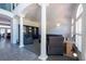 Bright living area with elegant columns, tiled floors, sleek furniture, and arched windows at 5305 Lenoir Ct, Plant City, FL 33566