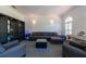 Bright living room with modern furnishings, large windows and an entertainment center with lighted display shelves at 5305 Lenoir Ct, Plant City, FL 33566