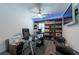 Spacious office with a ceiling fan, built in shelving, and a tv at 5305 Lenoir Ct, Plant City, FL 33566