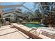 Beautiful enclosed pool featuring a waterfall, lush landscaping, and ample seating at 5305 Lenoir Ct, Plant City, FL 33566
