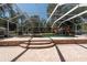 A stunning screened in pool featuring a unique rock waterfall at 5305 Lenoir Ct, Plant City, FL 33566