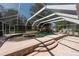 Beautiful screened pool with waterfall feature and a tanning ledge for the ultimate relaxation experience at 5305 Lenoir Ct, Plant City, FL 33566