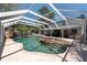 Beautiful in-ground pool with brick surround, waterfall feature and screened enclosure at 5305 Lenoir Ct, Plant City, FL 33566