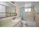 A clean bathroom featuring a tub with shower, white toilet, and vanity sink at 5480 Orange Blossom N Rd, Pinellas Park, FL 33782