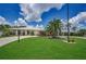 Expansive home with lush landscaping, featuring a circular driveway and palm trees at 5480 Orange Blossom N Rd, Pinellas Park, FL 33782