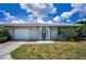Charming single-story home with well-maintained lawn and a decorative front door at 5480 Orange Blossom N Rd, Pinellas Park, FL 33782