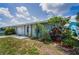 Cozy home with well-manicured landscaping, features a mix of stone and classic siding at 5480 Orange Blossom N Rd, Pinellas Park, FL 33782