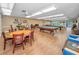 Spacious game room with pool tables, card tables, and comfortable seating at 5480 Orange Blossom N Rd, Pinellas Park, FL 33782