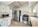 Bright kitchen featuring stainless steel refrigerator and light wood flooring at 5480 Orange Blossom N Rd, Pinellas Park, FL 33782