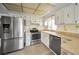 Bright kitchen with stainless steel appliances and countertops with backsplash at 5480 Orange Blossom N Rd, Pinellas Park, FL 33782
