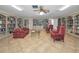 Cozy library featuring built-in bookshelves, comfortable seating, and tiled floors at 5480 Orange Blossom N Rd, Pinellas Park, FL 33782