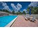 Sparkling pool area with lounge chairs and umbrellas for relaxation at 5480 Orange Blossom N Rd, Pinellas Park, FL 33782