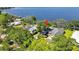 Picturesque aerial view of a lakefront home nestled among lush trees with dock access at 550 George S St, Tarpon Springs, FL 34688
