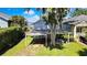 Spacious backyard featuring covered patios, mature trees, and a serene outdoor living space at 550 George S St, Tarpon Springs, FL 34688