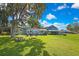 Spacious backyard with a fire pit, outdoor seating, and serene views of the surrounding landscape at 550 George S St, Tarpon Springs, FL 34688