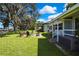 Lush backyard with mature trees and seating, perfect for outdoor gatherings at 550 George S St, Tarpon Springs, FL 34688