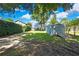 View of backyard with storage shed, featuring mature trees adding shade and character to the landscape at 550 George S St, Tarpon Springs, FL 34688