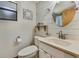 Compact bathroom with shiplap walls features a round mirror and a classic vanity at 550 George S St, Tarpon Springs, FL 34688