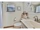 Cozy bathroom with shiplap walls features a round mirror and a classic vanity at 550 George S St, Tarpon Springs, FL 34688