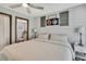 Stylishly decorated bedroom featuring shiplap wall, ceiling fan and ensuite bathroom at 550 George S St, Tarpon Springs, FL 34688
