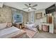 Charming bedroom with twin beds, rustic wooden walls, and a decorative vanity at 550 George S St, Tarpon Springs, FL 34688