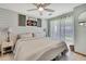 Cozy bedroom featuring a ceiling fan, shiplap accent wall, and natural light from the window at 550 George S St, Tarpon Springs, FL 34688