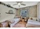 Comfortable bedroom with two twin beds, wood paneling, and a cozy atmosphere at 550 George S St, Tarpon Springs, FL 34688