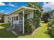 Charming home exterior with vines and flowers, nestled in a lush green yard at 550 George S St, Tarpon Springs, FL 34688