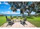 Charming backyard firepit area overlooking the lake and lush lawn at 550 George S St, Tarpon Springs, FL 34688