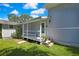 Charming front porch with decorative plants, offering a welcoming entrance to the home at 550 George S St, Tarpon Springs, FL 34688