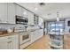Modern white kitchen with island and view from kitchen sink at 550 George S St, Tarpon Springs, FL 34688