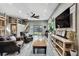 Spacious living room with hardwood floors, comfortable armchairs, and sliding doors to the outdoor space at 550 George S St, Tarpon Springs, FL 34688