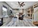 Spacious living room with bunkhouse decor features hardwood floors, a ceiling fan, and unique furnishings at 550 George S St, Tarpon Springs, FL 34688