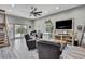 Inviting living area featuring hardwood floors, comfortable seating, and a sliding glass door to outdoor views at 550 George S St, Tarpon Springs, FL 34688