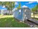 Charming backyard storage shed with ramp access on a well-maintained lawn, offering practical outdoor solutions at 550 George S St, Tarpon Springs, FL 34688