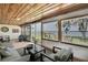 Bright sunroom showcases expansive windows with water and backyard views, complemented by comfortable seating at 550 George S St, Tarpon Springs, FL 34688