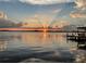 Tranquil sunset reflecting over a serene lake, enhanced by a private dock at 550 George S St, Tarpon Springs, FL 34688